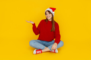 Concept of people, girl in santa hat on yellow background