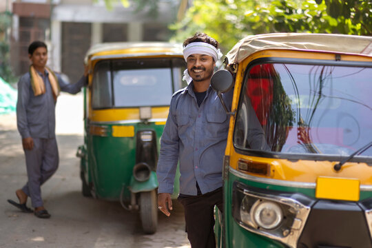 Portrait of auto rickshaw drivers standing at auto stand