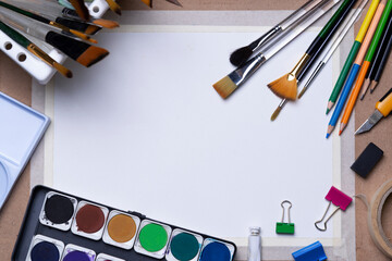 White drawing paper watercolor cartridges multi-sized brushes color pencils paper clips multi-colors