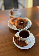 Fresh amazing simit and black tea. Traditional turkey breakfast food. Beautiful appetites bakery background. Wooden table.