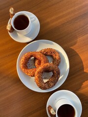 Fresh amazing simit and black tea. Traditional turkey breakfast food. Beautiful appetites bakery background. Wooden table.