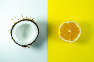 Coconut with orange. Creative composition of coconut and orange. He was lying flat. The concept of...