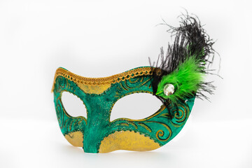 Carnival mask with feathers on a white background