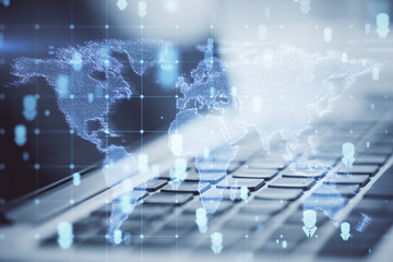 Close up of laptop with abstract glowing map hologram on blurry background. Digital world, transformation and future cyber space concept. Double exposure.