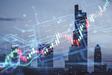 Creative candlestick forex chart index hologram on blurry night city buildings wallpaper. Trade, business market and finance analysis concept. Double exposure.