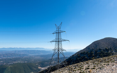 A electricity transmission tower or pylon on top of mountain.