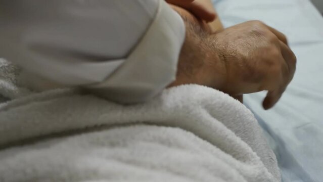 The process of massaging the female buttocks with both hands by a man masseur close-up. Lymphatic drainage body massage.