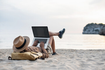 Young woman using laptop computer on beach, freelancer girl working remote, Freelance work, online learning, distant work concept. - 542624614