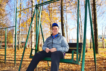 An autistic guy has fun riding a swing