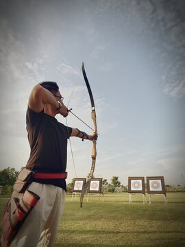 Archer Holding Bow And Aiming For Target