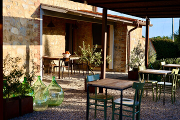 Obraz premium Image of a empty coffee tables arranged in backyard of a house. Autumn in Tuscany, Italy.