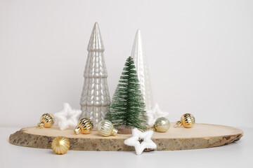 Modern Christmas trees. Decorative Beige, White and Green Christmas Decoration on a Wooden Stand with a Gray background. Nordic Festive Decor. Boho, Scandinavian Style Design. Trendy Minimal Ornament.