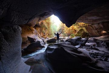 Adventurous woman standing inside a cave. Adventure Travel. Little Huson Caves Park, Vancouver...