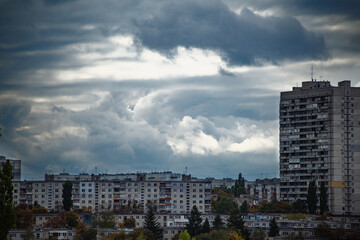 Thunderclouds over the city. A storm is approaching the city. Autumn clouds over city buildings....