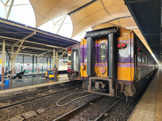 The train stops to pick up passengers at Hua Lamphong Railway Station in Bangkok, Thailand.