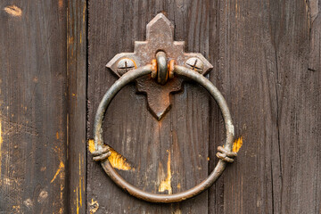 Iron ring on an old scratched wooden door Konigsberg Cathedral. Closeup.