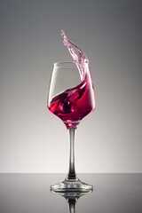 Glass of wine on grey background.