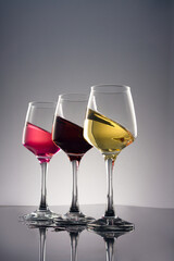 Glass of wine on grey background.