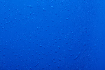 Water drops on blue background and texture