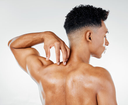 Skincare, back muscle of man and strong for wellness, being confident with studio background. Rear view, male and fitness for body care, smooth and glow skin in bodybuilding or flex muscular anatomy.