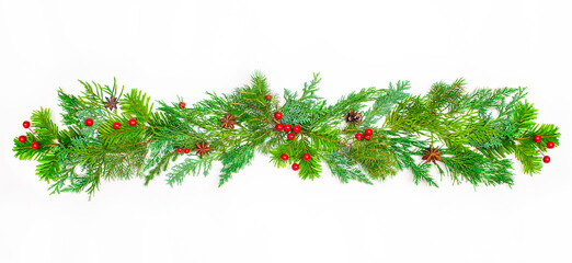 Christmas border frame of coniferous branches red berries and pine cones on white background with...