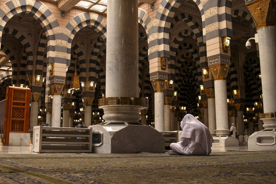 Muslims praying inside Nabawi Mosque. Interior view of Masjidil Nabawi (Nabawi Mosque) in Medina.