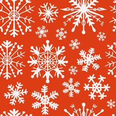 Seamless pattern of snowflakes on a red background