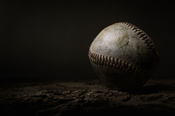 Baseball ball used closeup red stitching moody dark