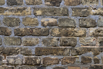 Old weathered beige brown brick wall background