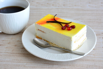 lemon cake with cup of coffee on beige background, close-up 