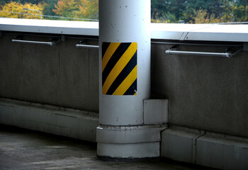 column made of reinforced concrete with stripes as protection against breaking. Obstacles such as...