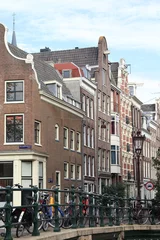 Deurstickers Amsterdam Binnen Brouwersstraat Street View with Historic House Facades, Bridge Railing and Paked Bicycles, Netherlands © Monica