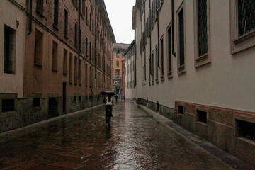 Narrow street in the old gothic town on a rainy day. Selective focus.