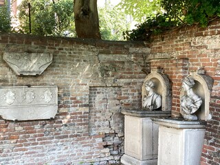 Old statues in the hidden gardens of Ca rezzonico in Venice, Italy