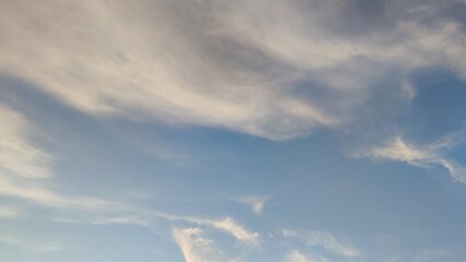 Blue sky with occasional clouds. Autumn day high in the sky translucent white cirrus and cumulus...