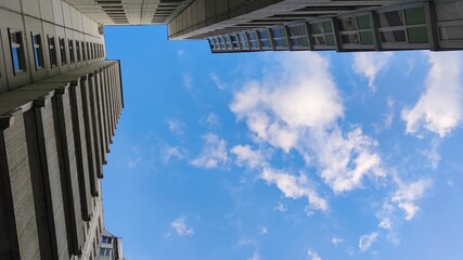 Corner of a high-rise building from rectangular lines. The light green concrete structure rises up the corner of the building from perpendicular lines, forming abstract shapes. © Andrew_Swarga