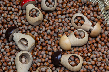 Basket with hazelnuts. A nutcracker in the form of a wooden mushroom. Tor review. Organic food, healthy food. Souvenir market
