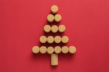 Christmas tree made of wine corks on red background, top view