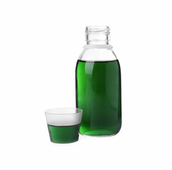 Bottle with measuring cup of syrup on white background. Cough and cold medicine