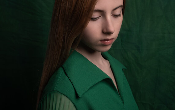 close portrait of girl in green in dark painterly renaissance style