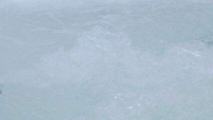 Water bubbling in hot tub, closeup view
