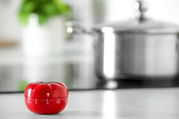 Kitchen timer in shape of tomato on white table indoors. Space for text