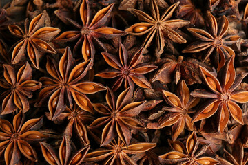 Aromatic anise stars as background, top view