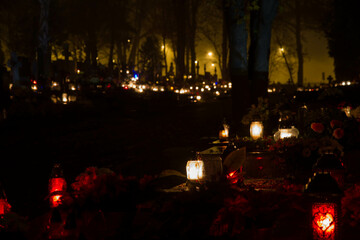 Votive candles burning at a cemetery at All Hallow Eve in Poland