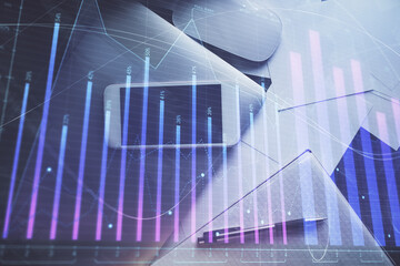 Multi exposure of forex graph hologram over desktop with phone. Top view. Mobile trade platform...