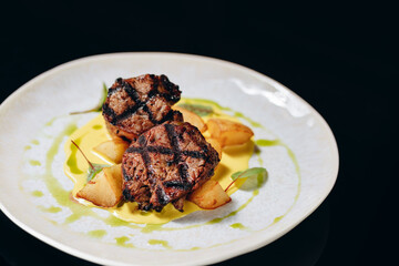 Veal medallion on a potato pillow, with cream sauce.