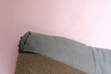 pink wall with old decorative pillow