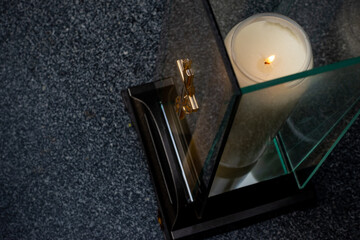 Candles and flowers on graves in the cemetery during the All Saint's Day. Taken during the day,...