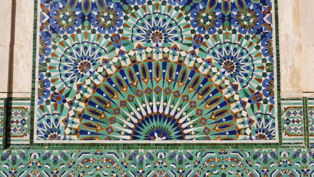 Colorful zellige tiles of a fountain in Morocco. Mosaic pattern,  traditional Islamic geometric design. Moroccan craft, handmade. 4k footage.
