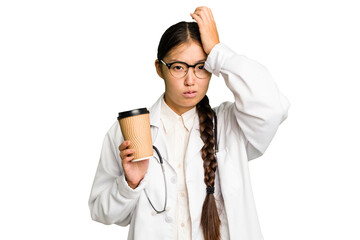 Young doctor asian woman holding a takeaway coffee isolated being shocked, she has remembered...